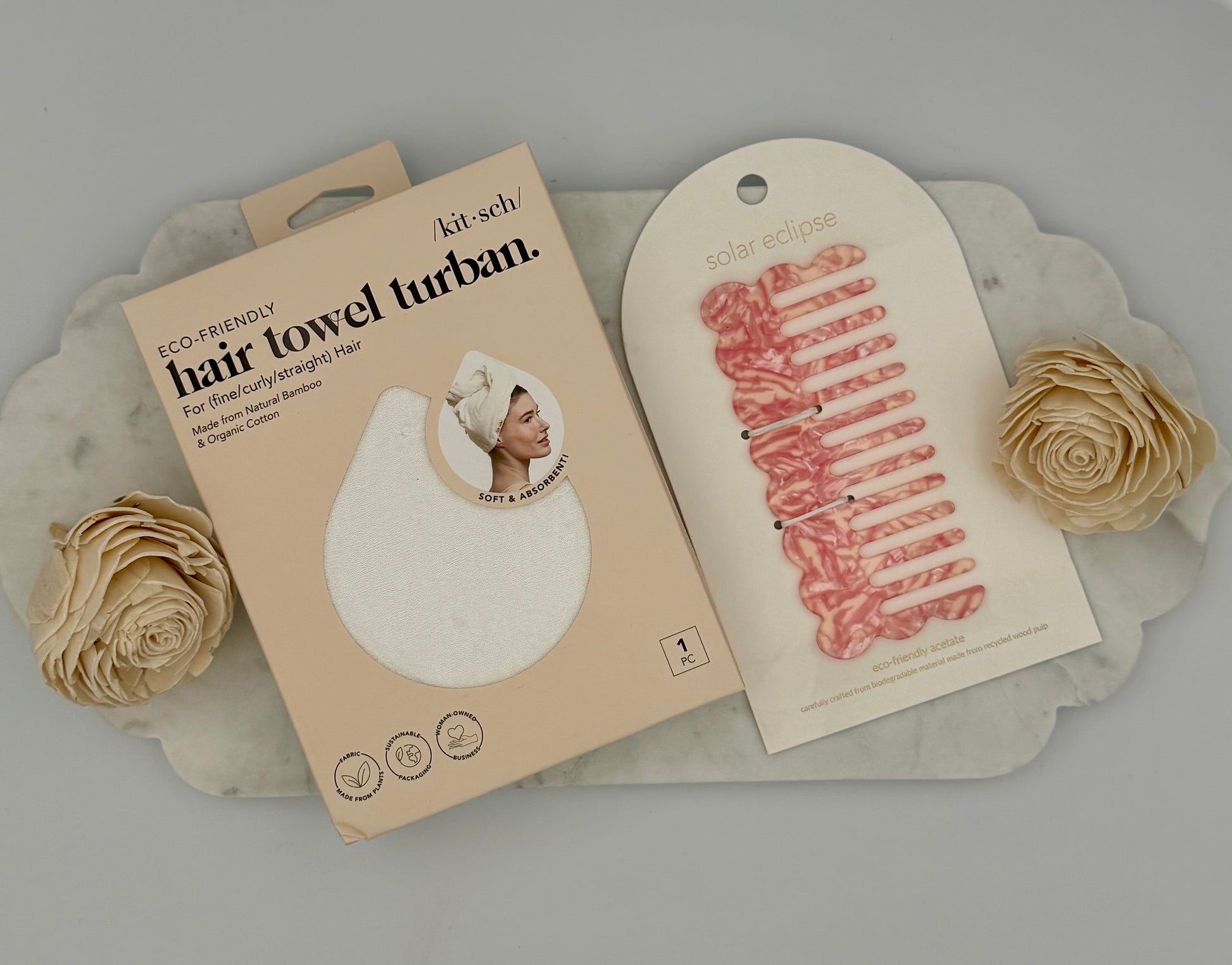Hair towel turban packaging with a floral decoration on a gray background