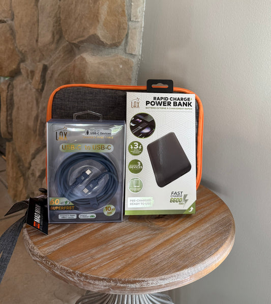 Packaged rapid charge power bank and USB-C cable on a wooden surface with stone wall background