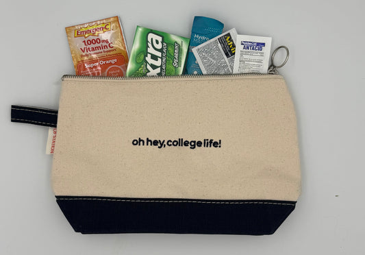 Beige pouch with 'oh hey, college life!' text, containing various small packets on a gray background